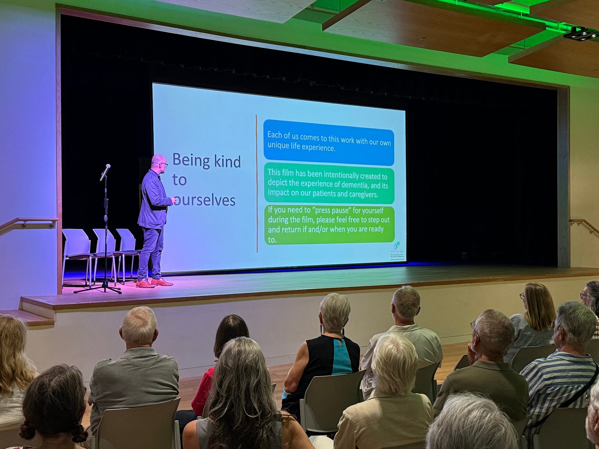 A man giving a presentation in front of a crowd